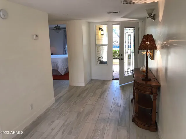 a view of entryway and hall with wooden floor