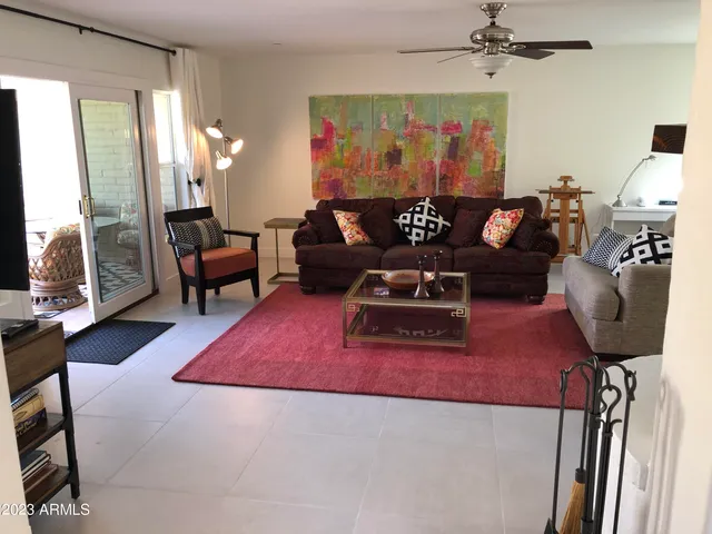 a living room with furniture rug and wooden floor