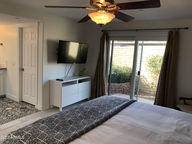 a bedroom with a bed and a flat screen tv