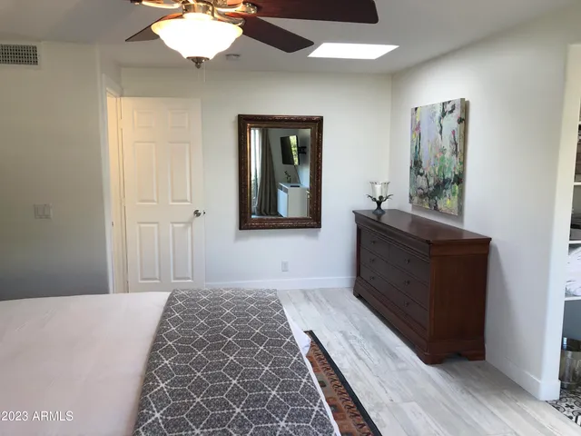 a bedroom with a bed and a mirror