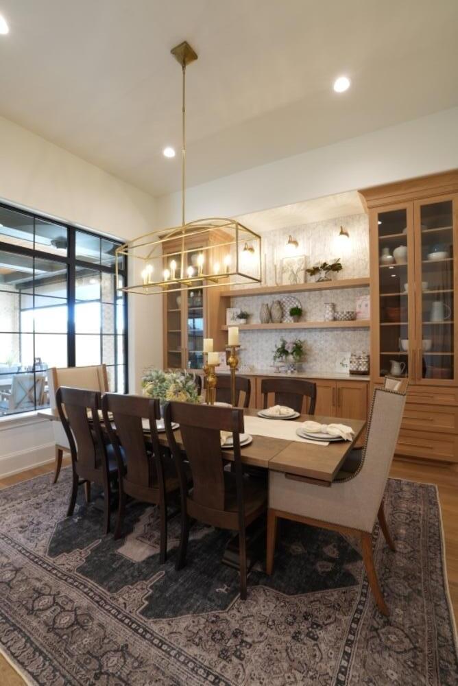 4101 149th Street Lubbock, TX 79423 - Photo 17 of 53 a dining hall with stainless steel appliances kitchen island granite countertop a dining table chairs and window