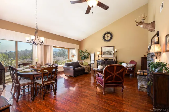 a living room with furniture a rug and a chandelier