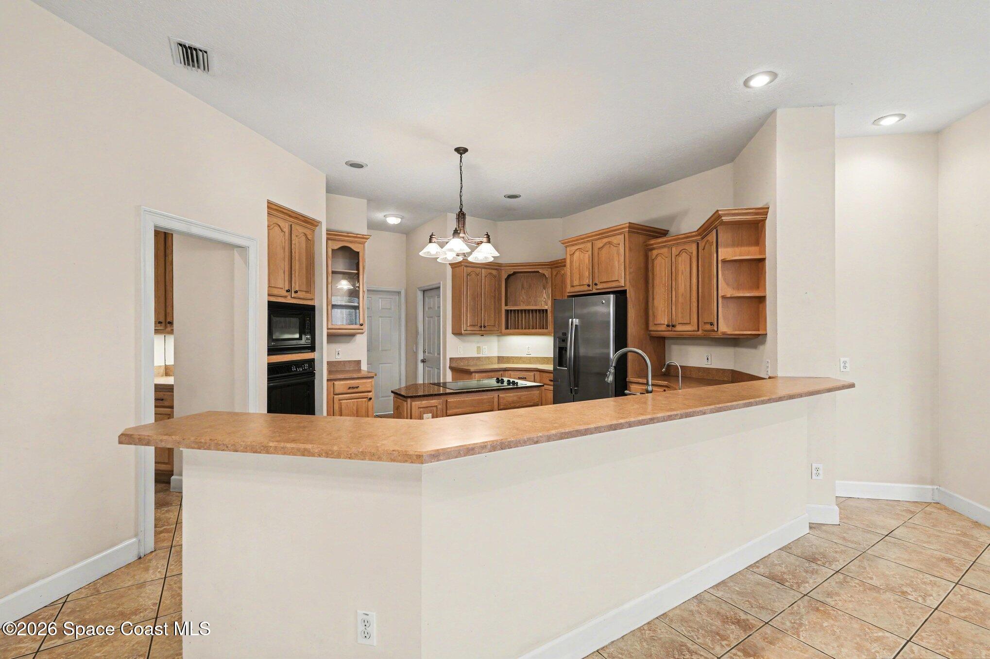 1399 Snapping Turtle Road Mims, FL 32754 - Photo 15 of 51 a view of a kitchen with a sink and refrigerator