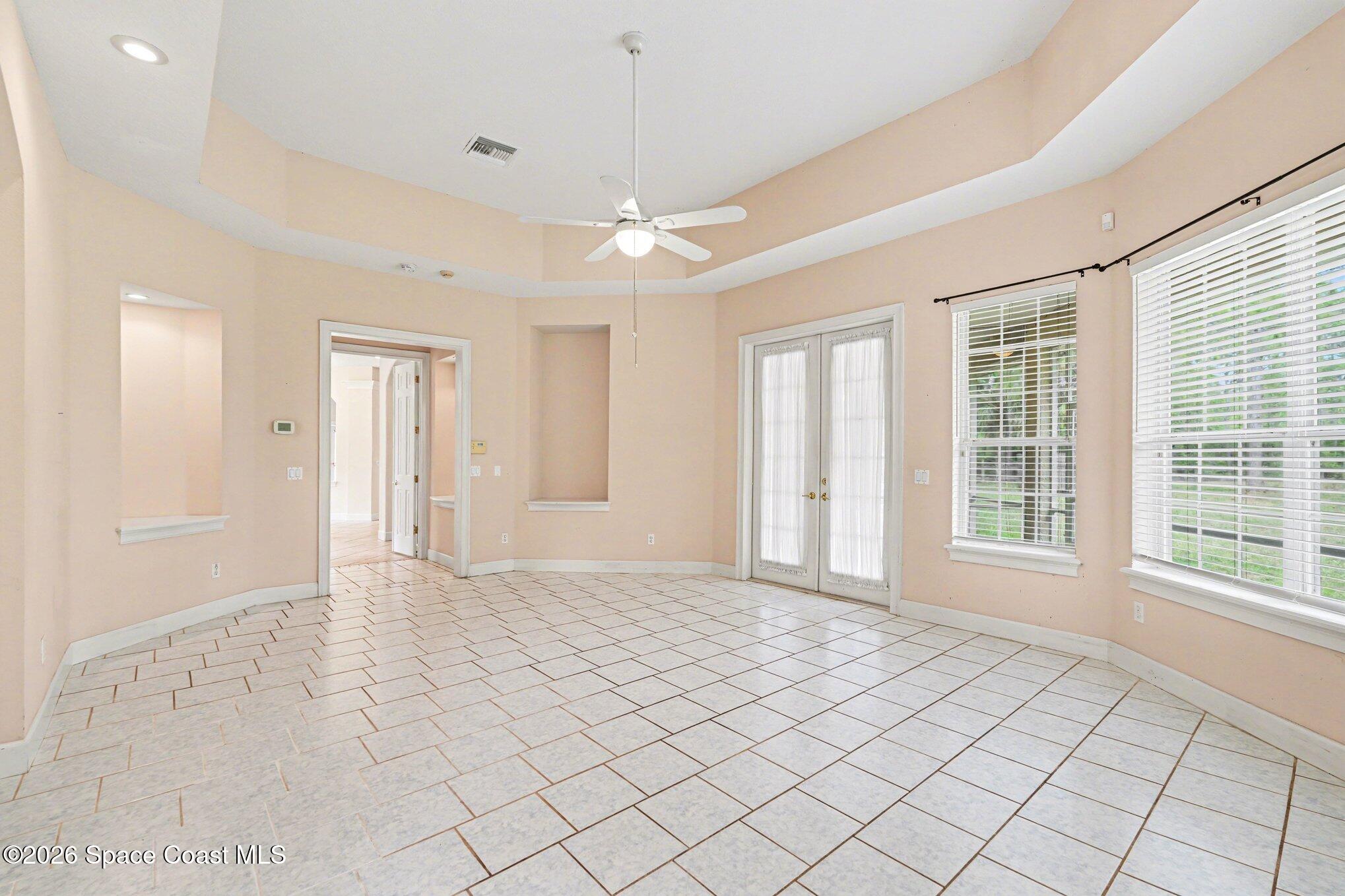 1399 Snapping Turtle Road Mims, FL 32754 - Photo 21 of 51 a view of an empty room with window and chandelier fan