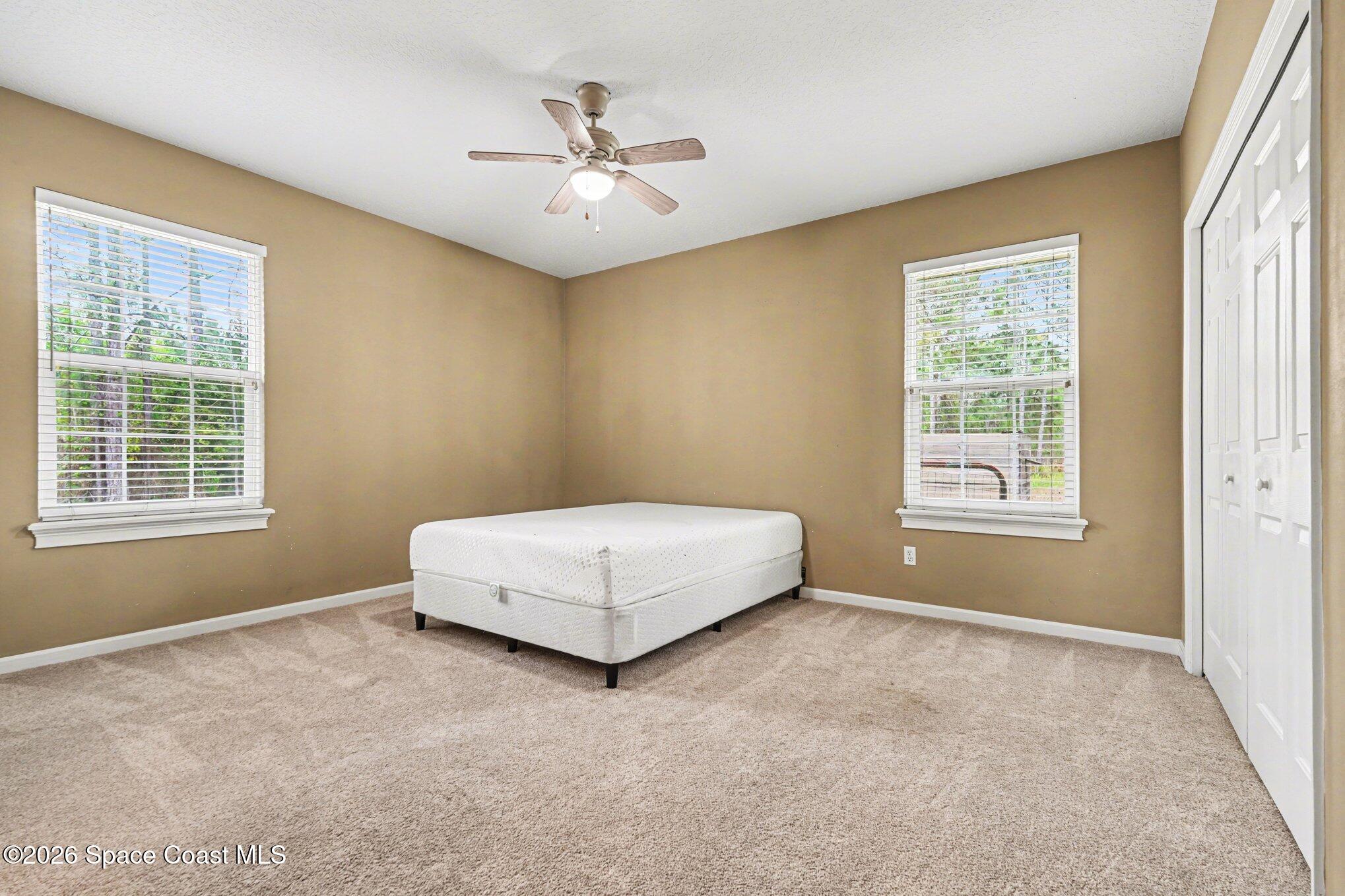 1399 Snapping Turtle Road Mims, FL 32754 - Photo 29 of 51 a spacious bedroom with a bed and a window