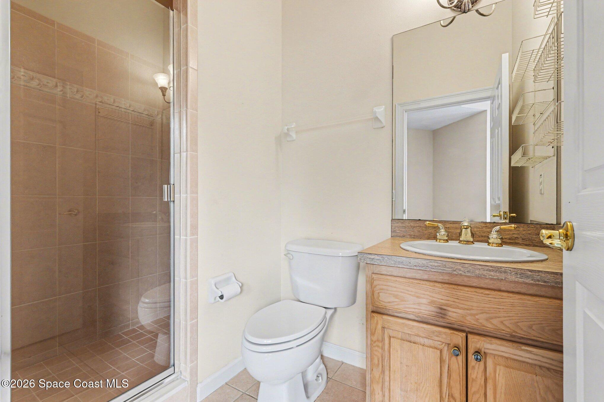 1399 Snapping Turtle Road Mims, FL 32754 - Photo 31 of 51 a bathroom with a granite countertop sink toilet a mirror and shower