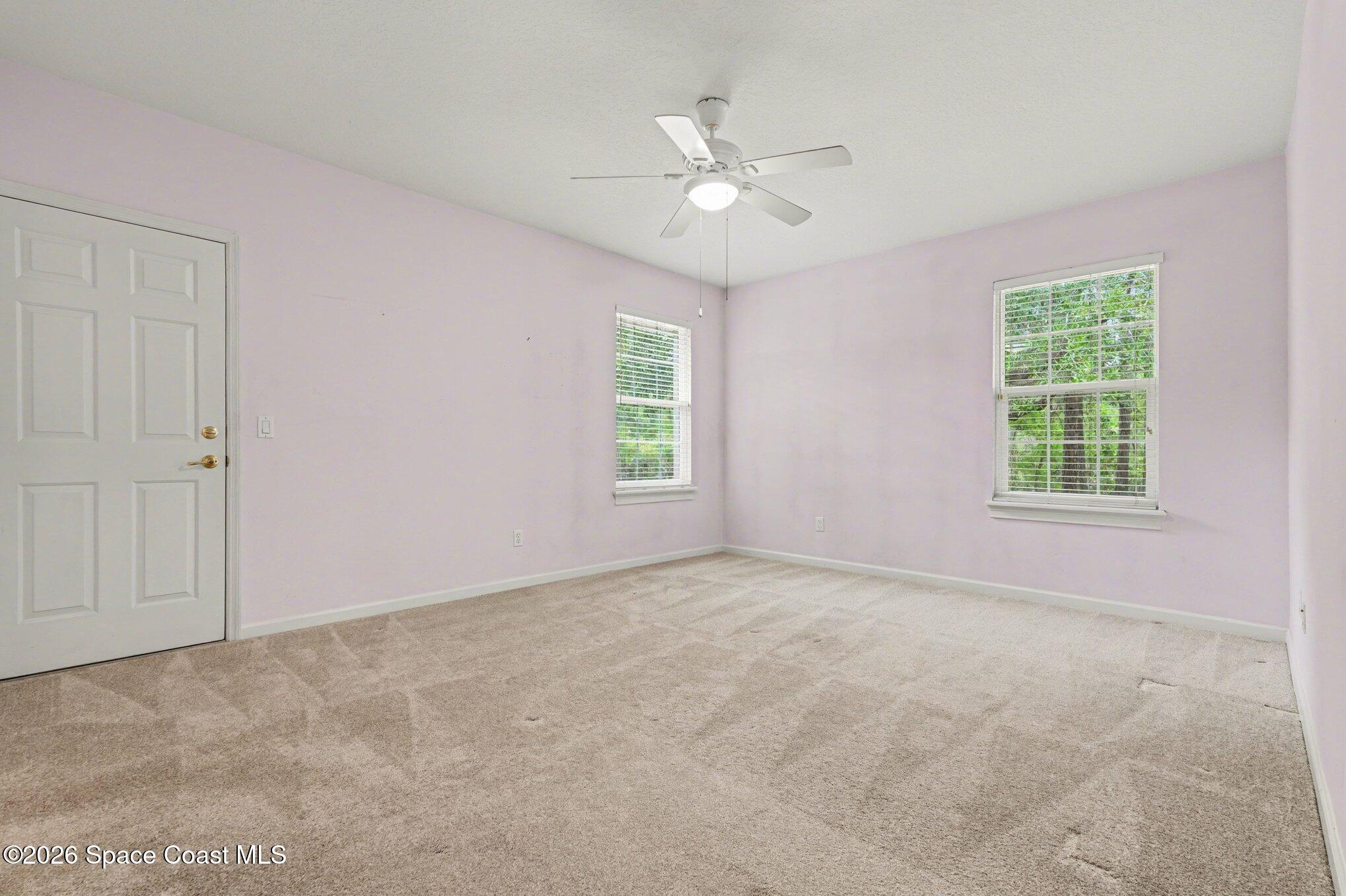 1399 Snapping Turtle Road Mims, FL 32754 - Photo 34 of 51 an empty room with windows and fan
