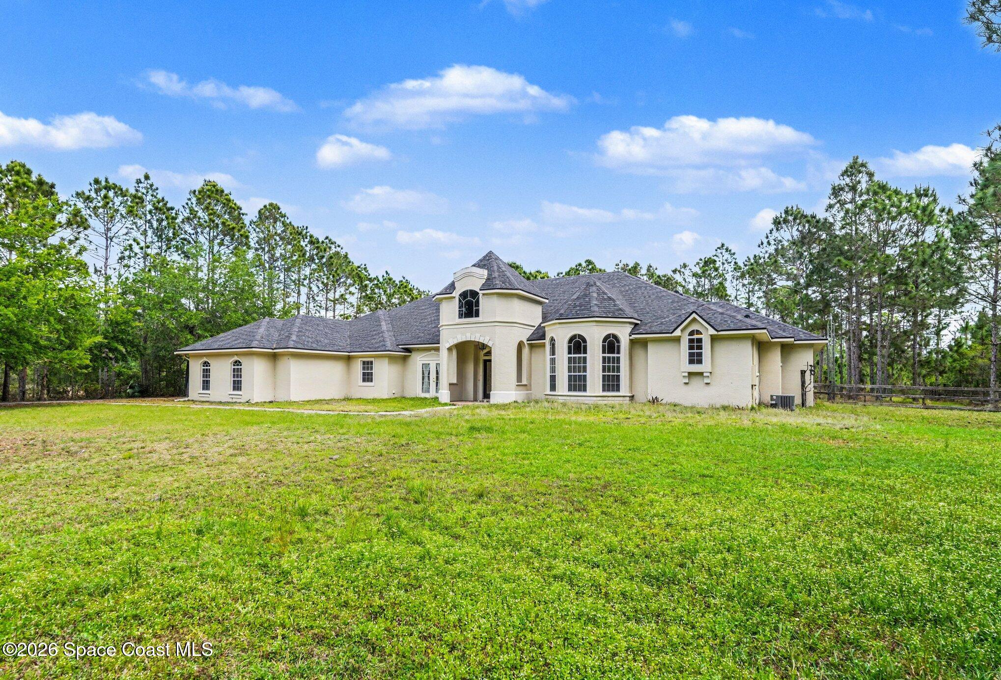 1399 Snapping Turtle Road Mims, FL 32754 - Photo 4 of 51 a front view of a house with a garden