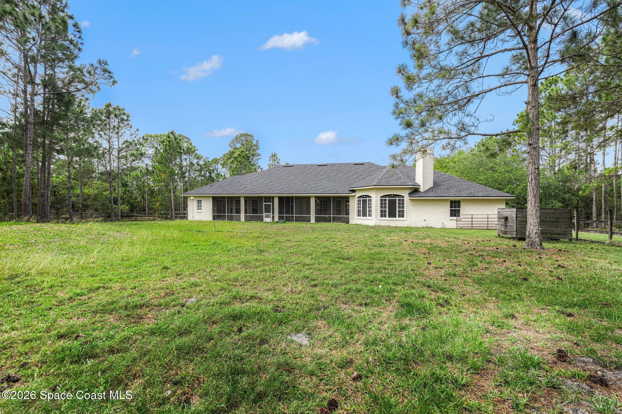 1399 Snapping Turtle Road Mims, FL 32754 - Photo 41 of 51 a front view of a house with a garden