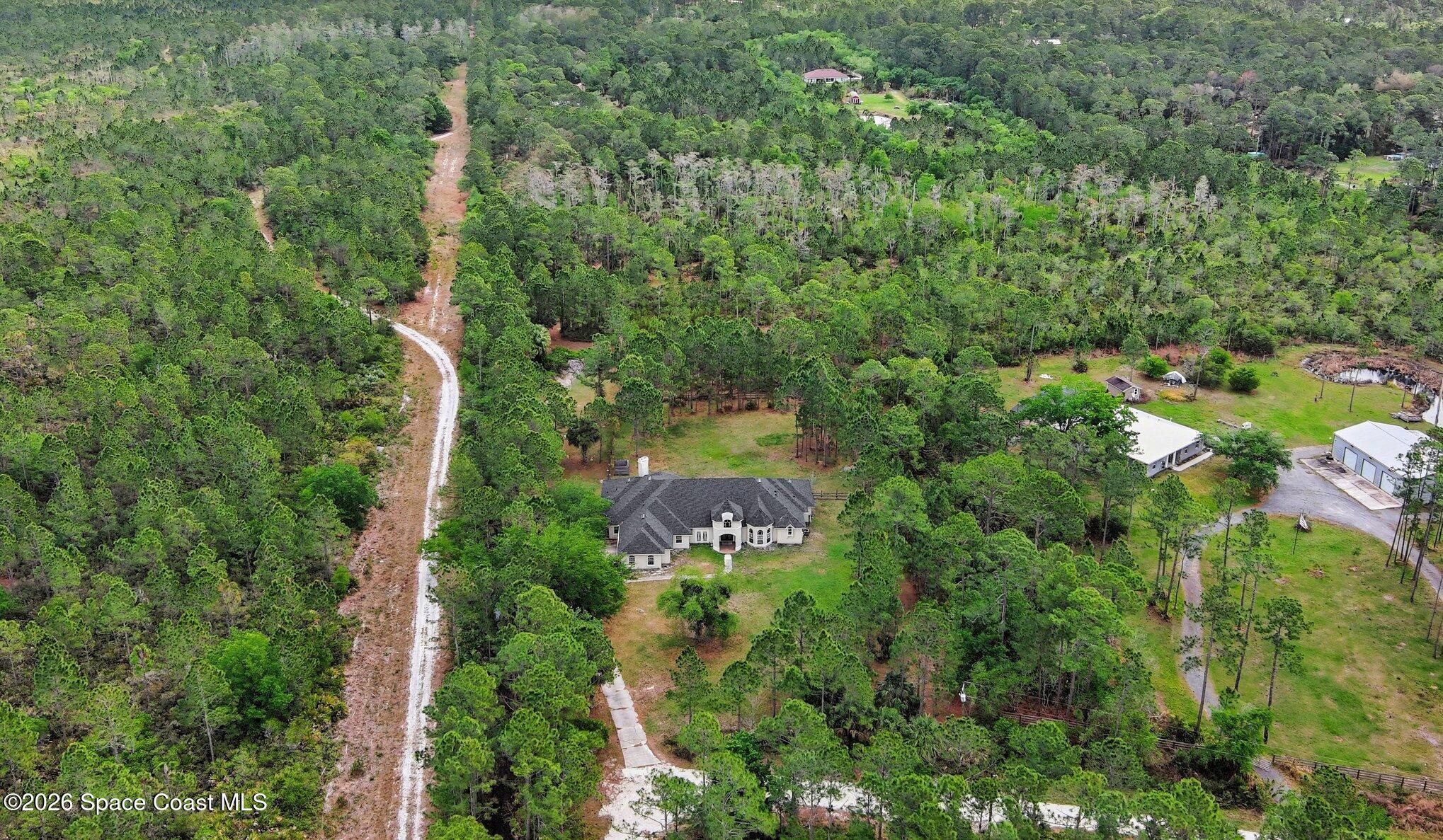 1399 Snapping Turtle Road Mims, FL 32754 - Photo 45 of 51 an aerial view of a house with a yard and lake view