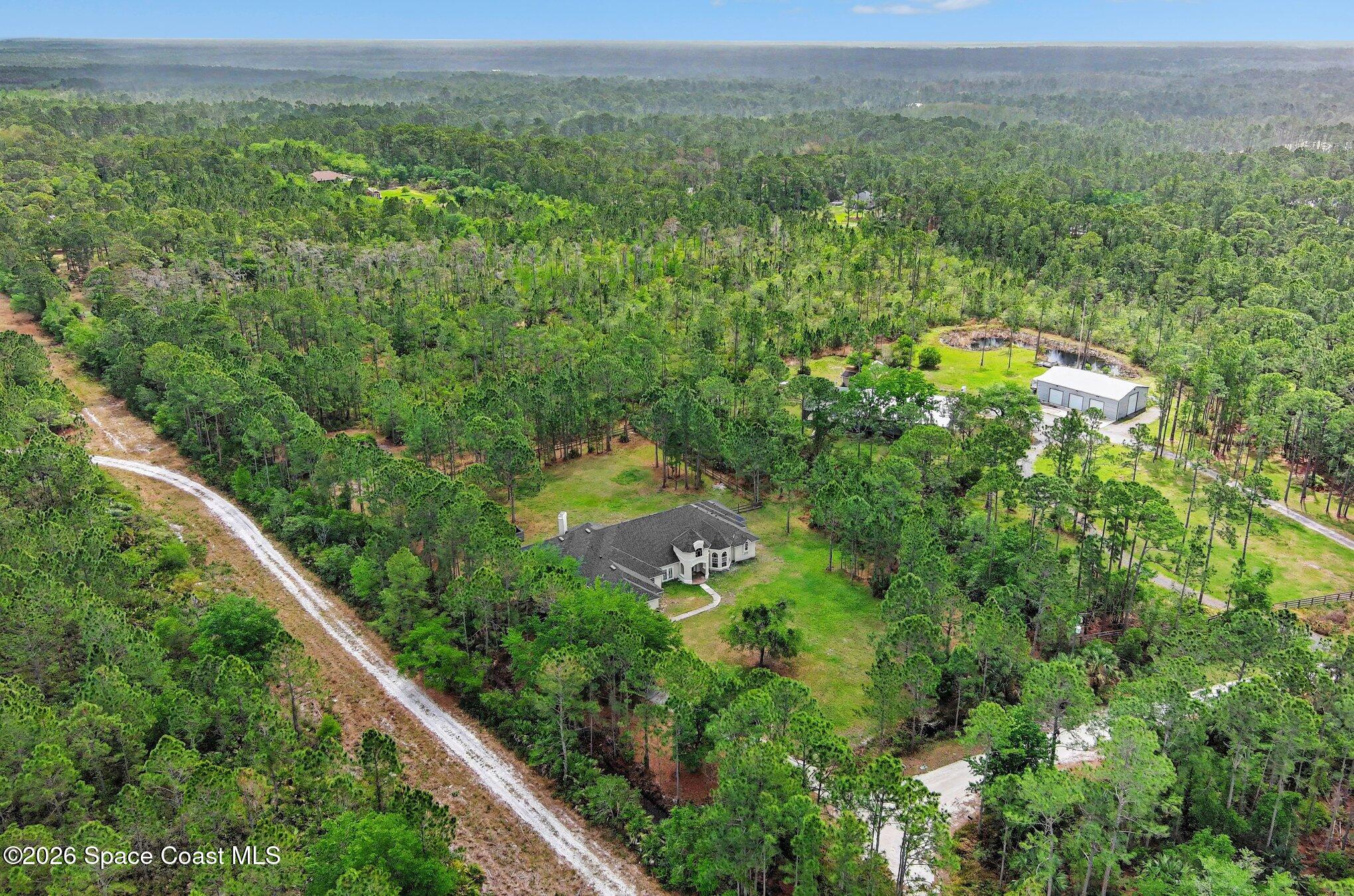 1399 Snapping Turtle Road Mims, FL 32754 - Photo 47 of 51 a view of a city with lush green forest