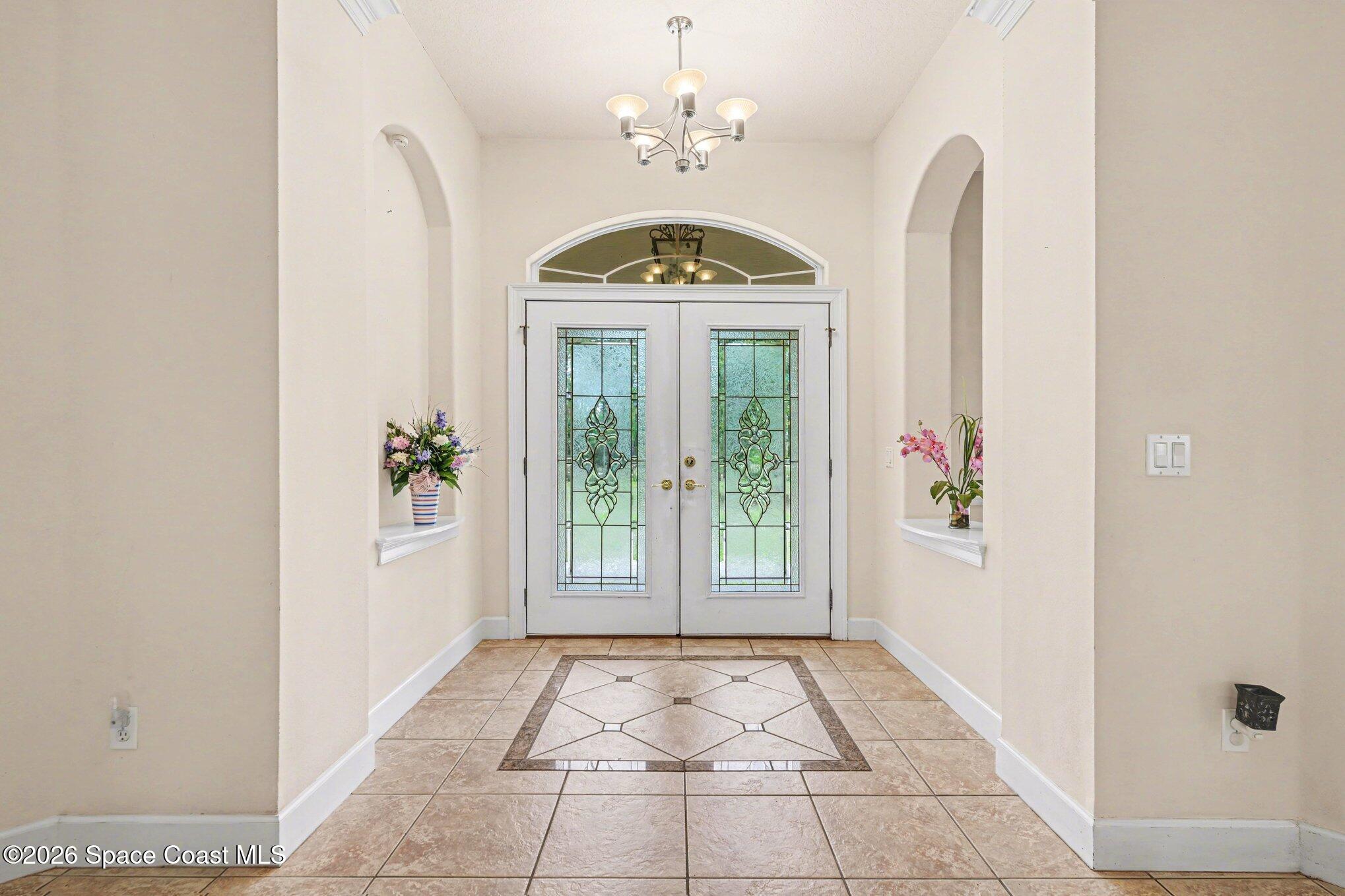 1399 Snapping Turtle Road Mims, FL 32754 - Photo 7 of 51 a view of an entryway with a chandelier