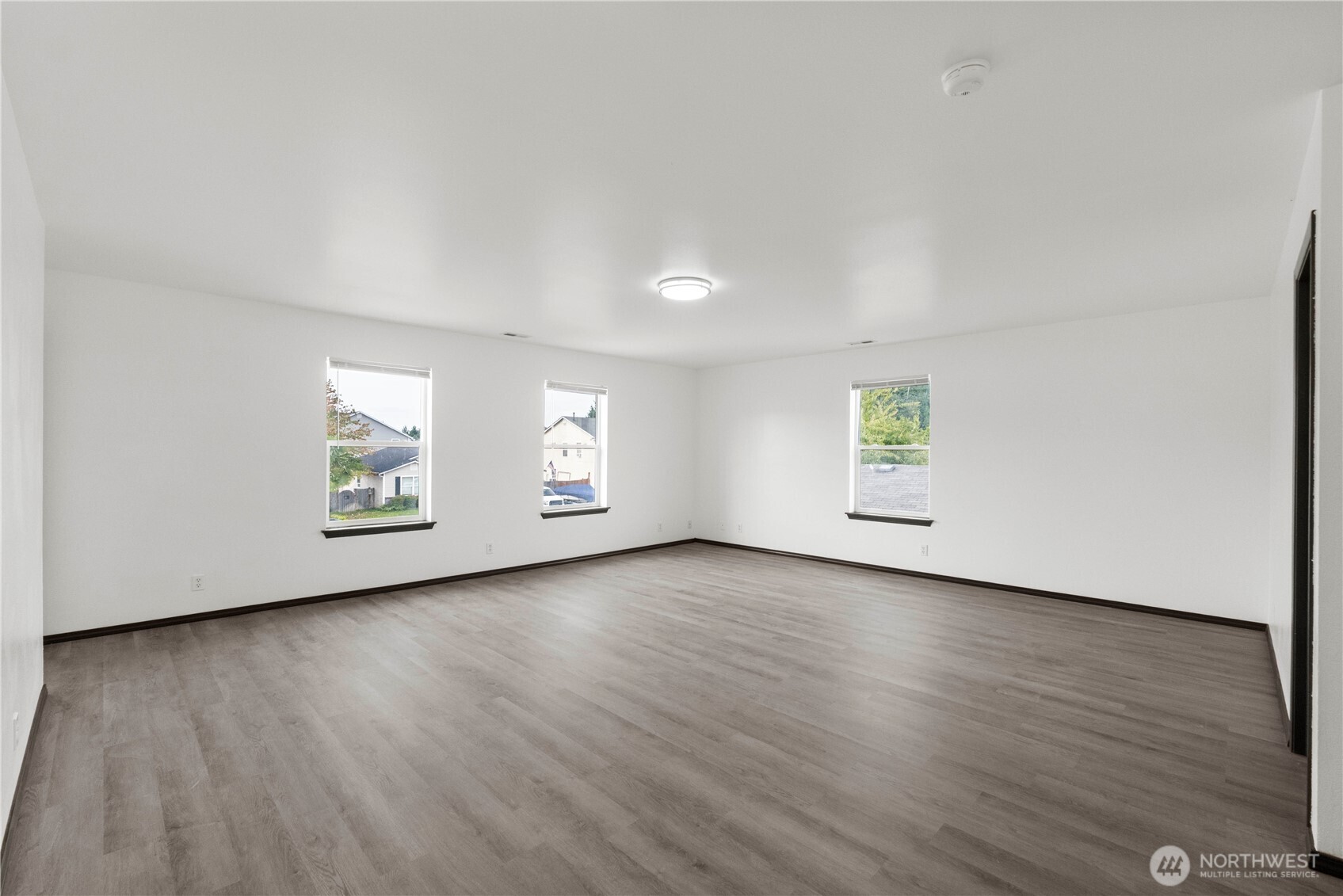 116 Mazza Street Northeast Orting, WA 98360 - Photo 16 of 39 an empty room with wooden floor and window