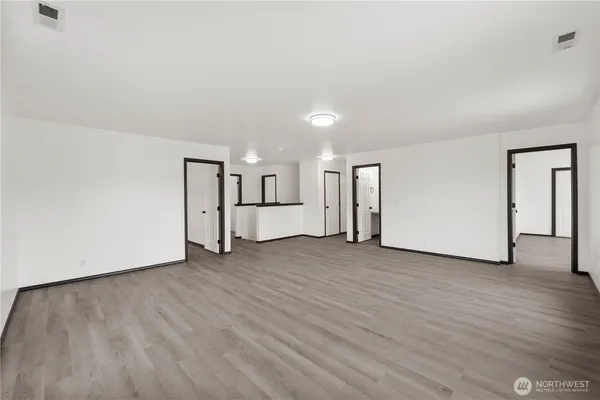 a view of a room with wooden floor