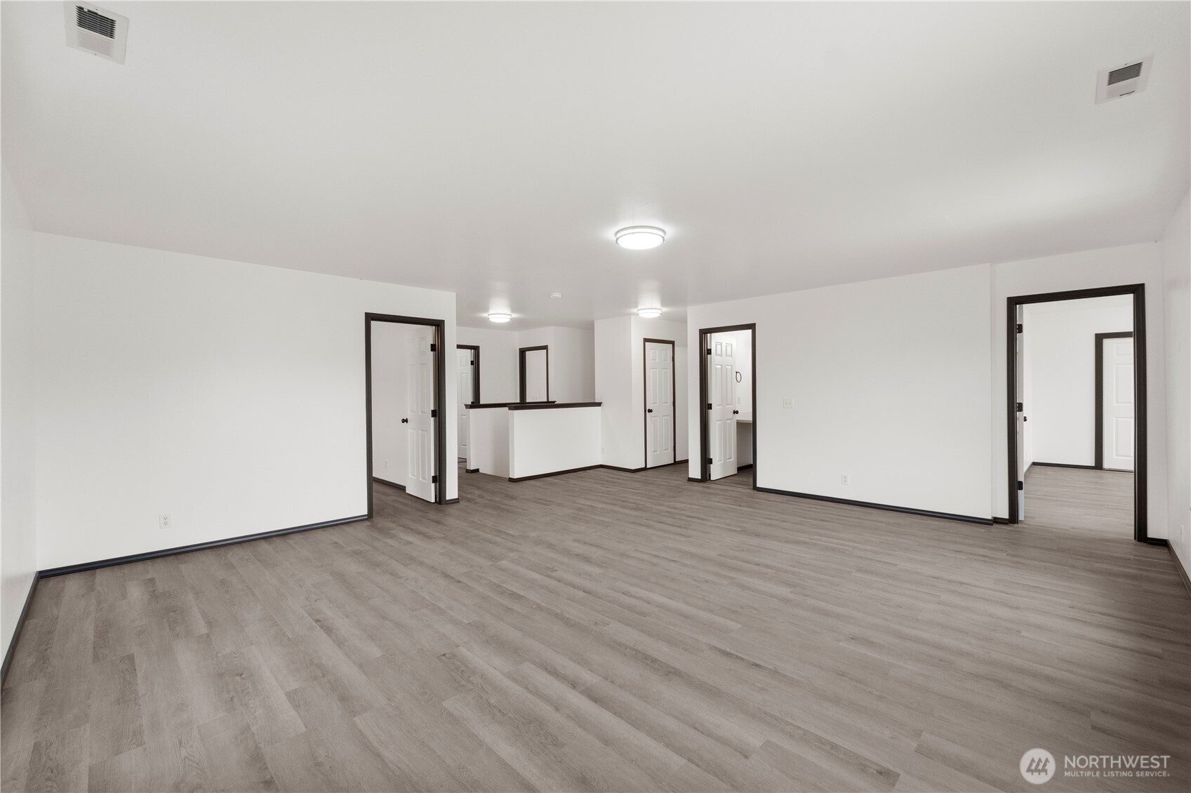116 Mazza Street Northeast Orting, WA 98360 - Photo 18 of 39 a view of a room with wooden floor