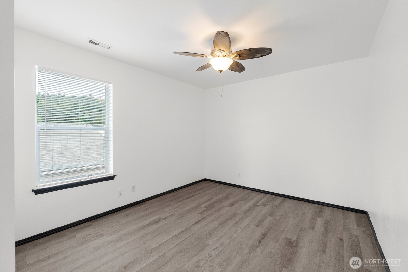 116 Mazza Street Northeast Orting, WA 98360 - Photo 20 of 39 wooden floor in an empty room with a window