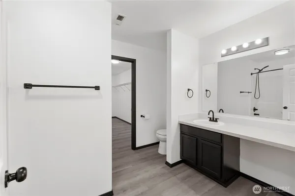 a bathroom with a double vanity sink a mirror and shower