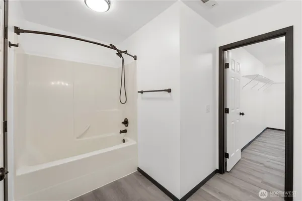 a bathroom with a bathtub and a shower