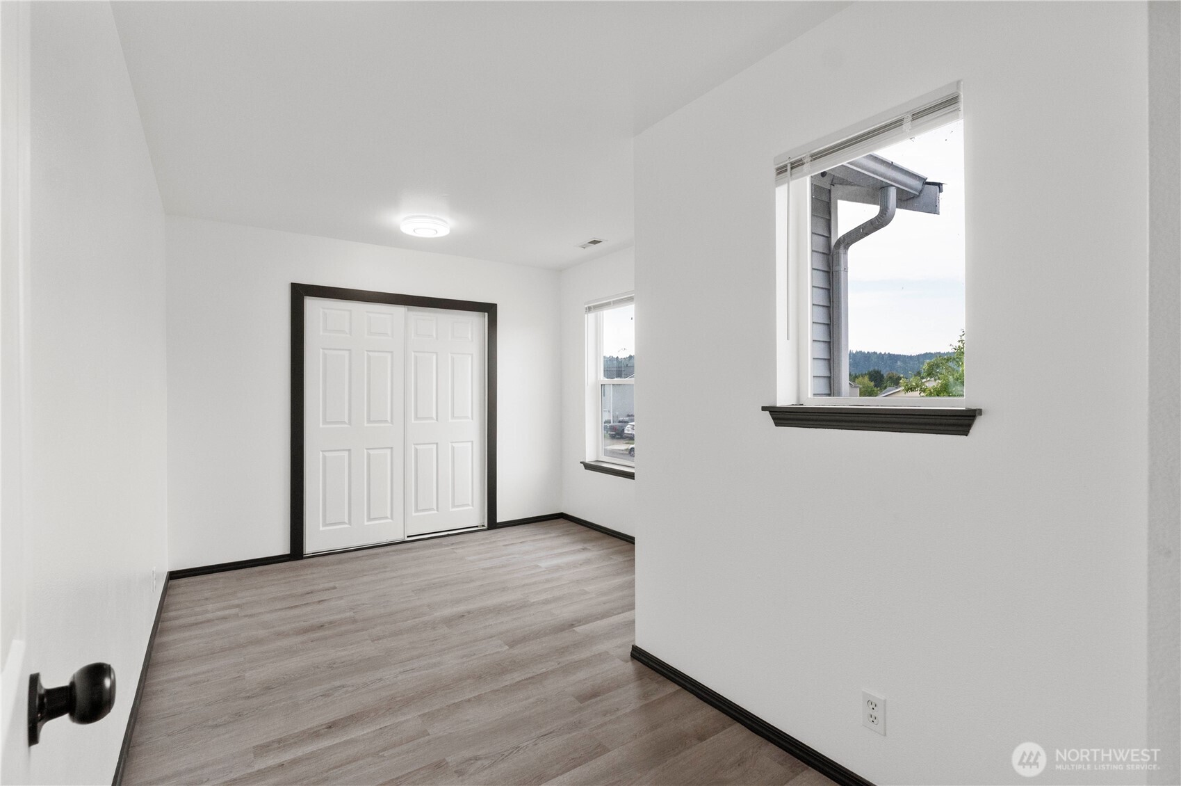 116 Mazza Street Northeast Orting, WA 98360 - Photo 30 of 39 an empty room with wooden floor and a window