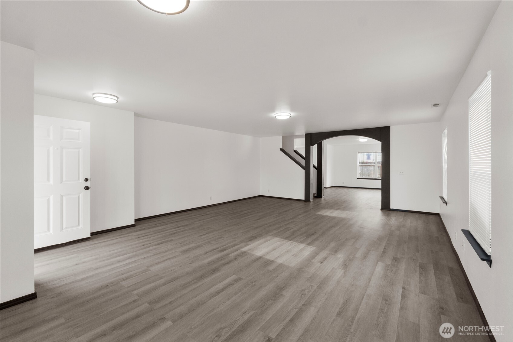 116 Mazza Street Northeast Orting, WA 98360 - Photo 3 of 39 an empty room with wooden floor and mirror