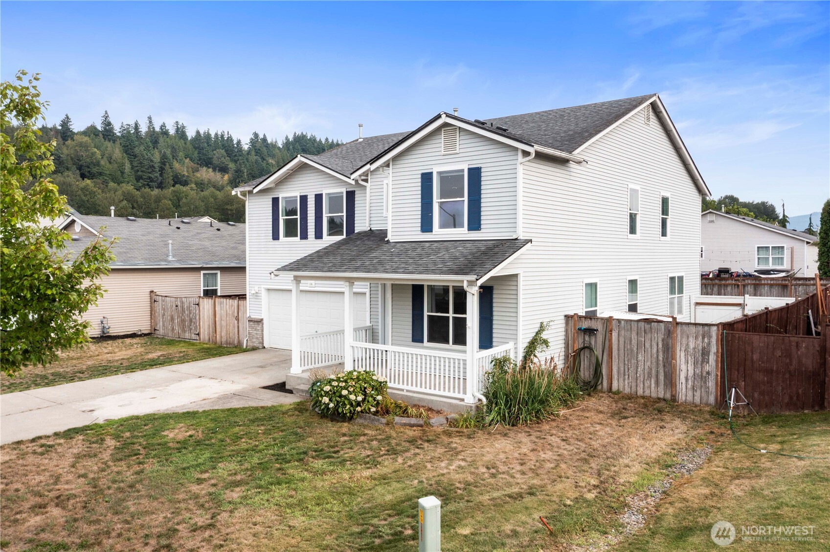 116 Mazza Street Northeast Orting, WA 98360 - Photo 38 of 39 a view of a yard in front of a house with plants and large tree