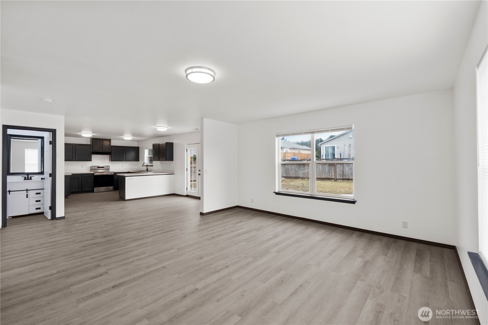 116 Mazza Street Northeast Orting, WA 98360 - Photo 6 of 39 a view of kitchen with furniture and wooden floor