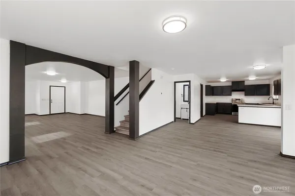 a view of a kitchen with a sink and a refrigerator
