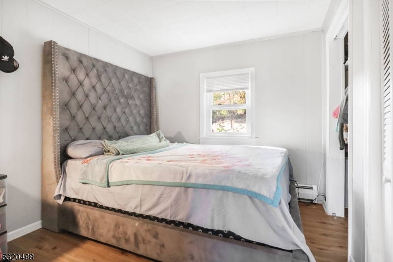 57 Terrace Avenue Butler, NJ 07405 - Photo 5 of 20 a bedroom with a bed and a painting on the wall