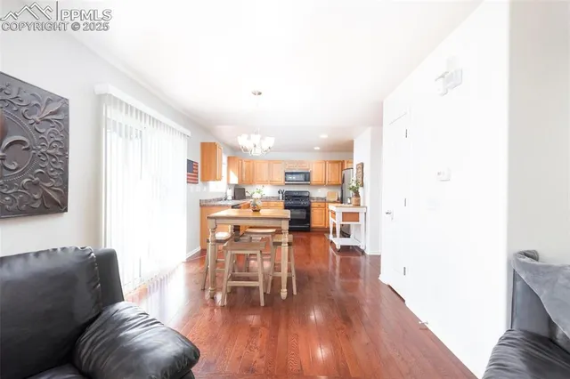 a living room with furniture and kitchen view