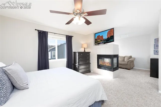 a bedroom with a bed and a fireplace