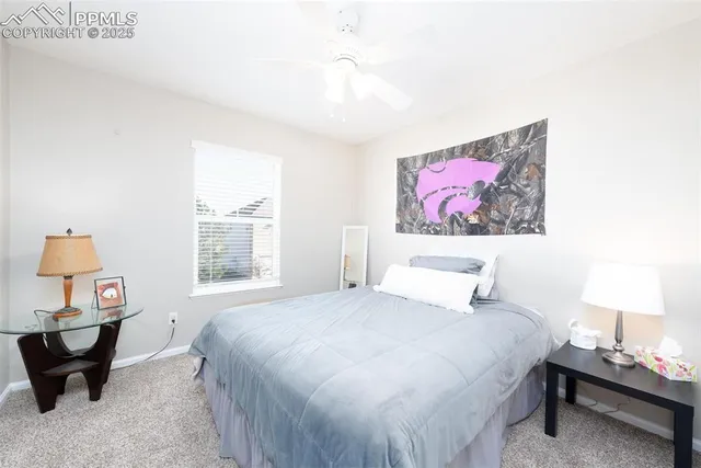 a bedroom with a bed a dresser and a window