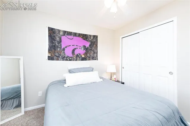 a bedroom with a bed and a painting on the wall