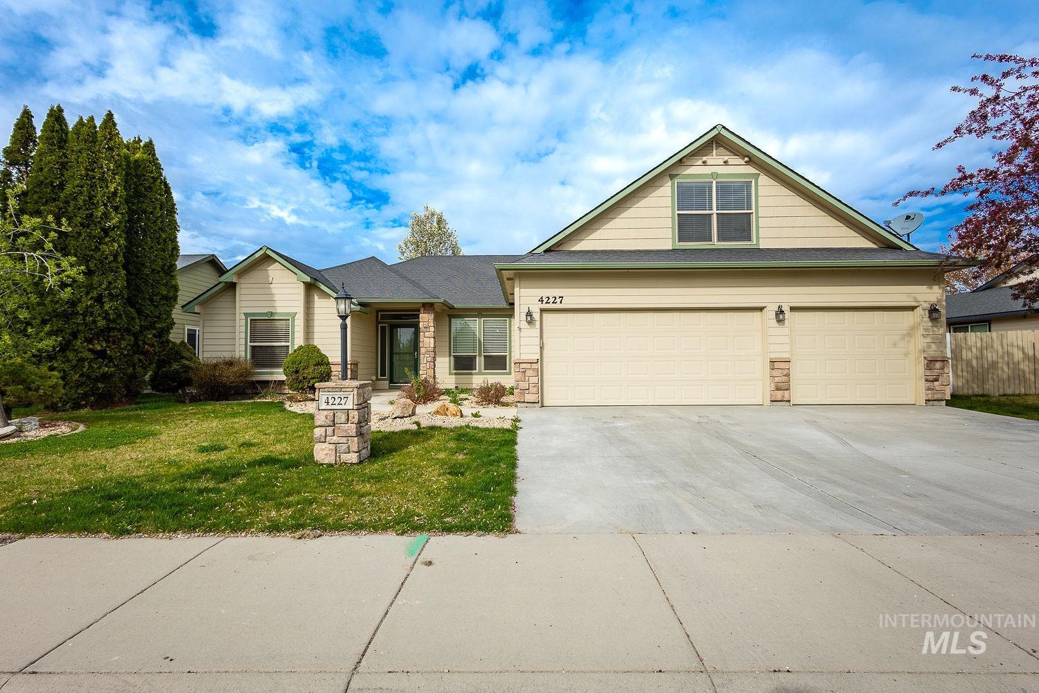 View of front of home featuring stone siding and concrete driveway