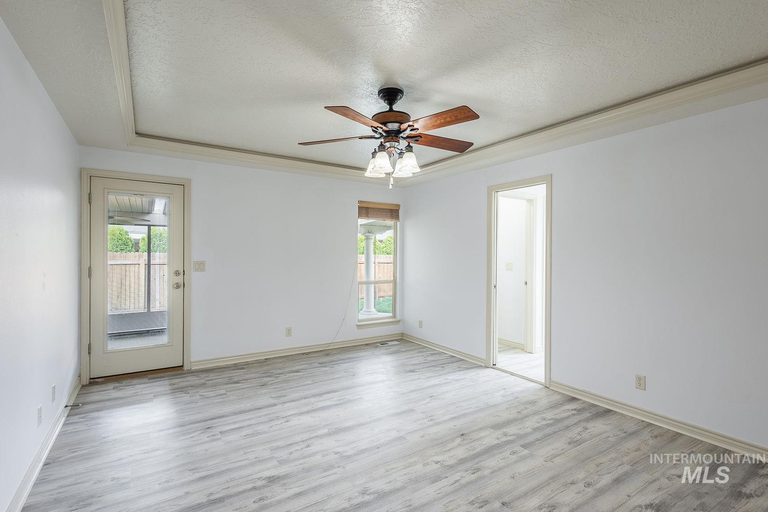 4227 North Rhodes Avenue Meridian, ID 83646 - Photo 18 of 42 Spare room featuring a textured ceiling, light wood-type flooring, and ceiling fan