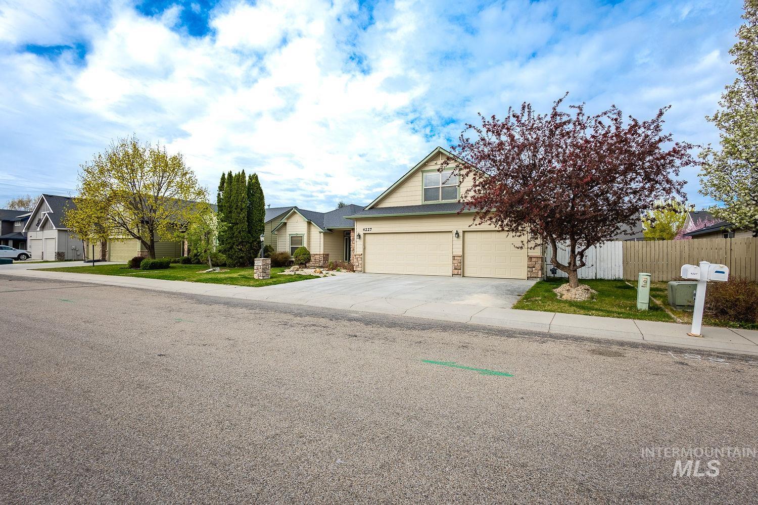 4227 North Rhodes Avenue Meridian, ID 83646 - Photo 2 of 42 View of front facade featuring stone siding, driveway, and a residential view