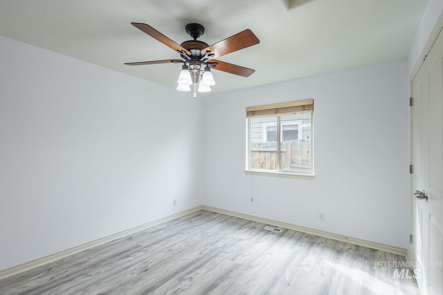 4227 North Rhodes Avenue Meridian, ID 83646 - Photo 29 of 42 Empty room with light wood-style floors and a ceiling fan