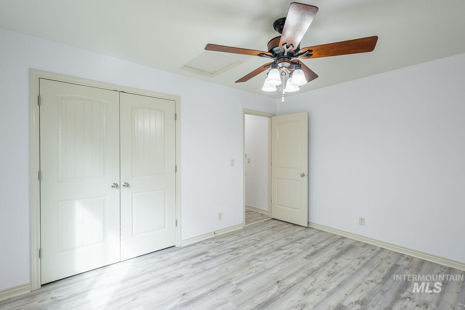 4227 North Rhodes Avenue Meridian, ID 83646 - Photo 30 of 42 Unfurnished bedroom with light wood-style floors, a closet, and a ceiling fan
