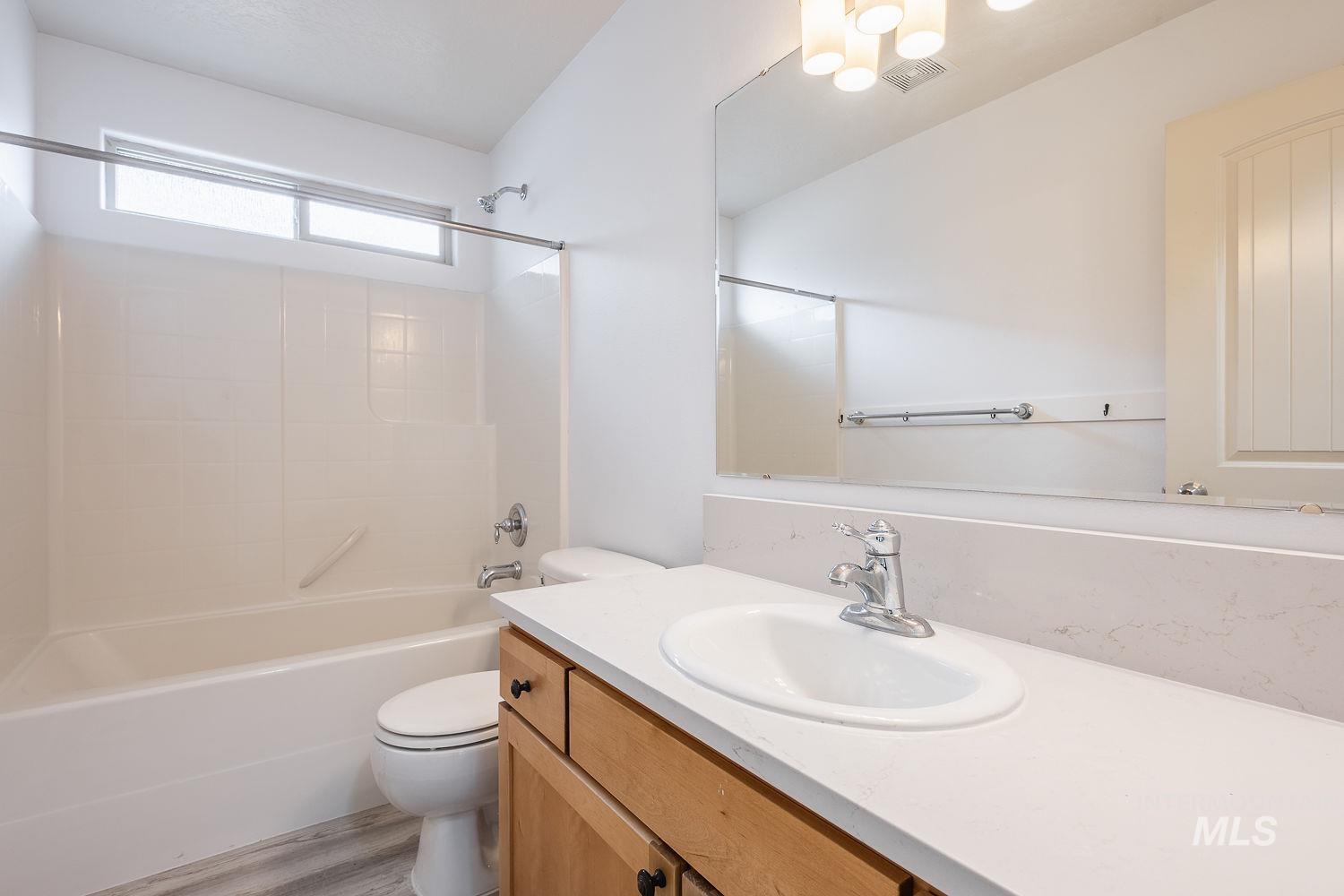 4227 North Rhodes Avenue Meridian, ID 83646 - Photo 31 of 42 Full bath with vanity, bathing tub / shower combination, and light wood finished floors