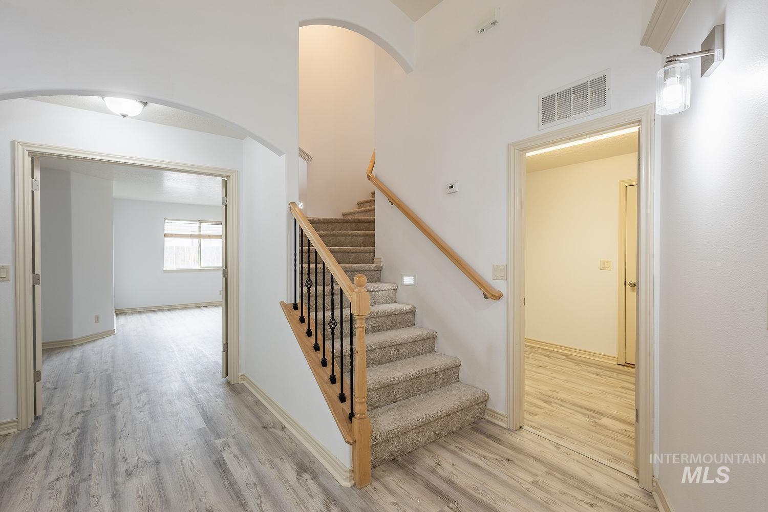 4227 North Rhodes Avenue Meridian, ID 83646 - Photo 34 of 42 Stairs with wood finished floors and a high ceiling