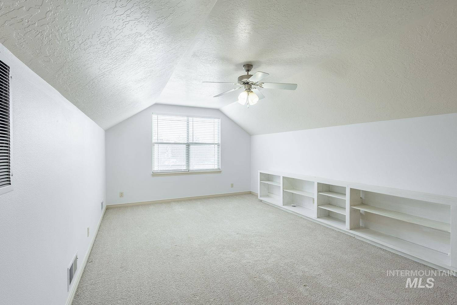 4227 North Rhodes Avenue Meridian, ID 83646 - Photo 35 of 42 Additional living space with carpet, a textured ceiling, and ceiling fan