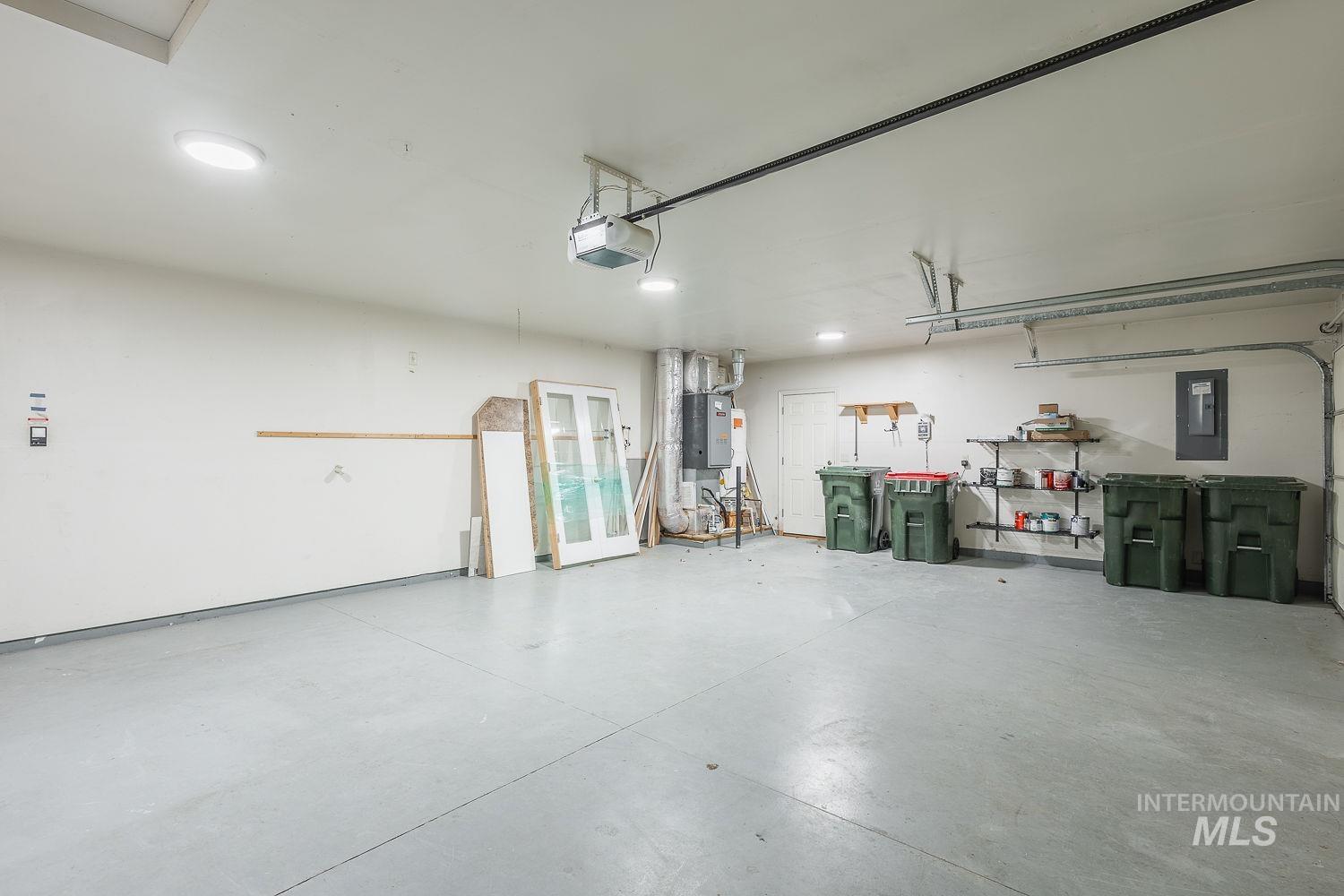 4227 North Rhodes Avenue Meridian, ID 83646 - Photo 39 of 42 Garage with french doors, electric panel, and a garage door opener