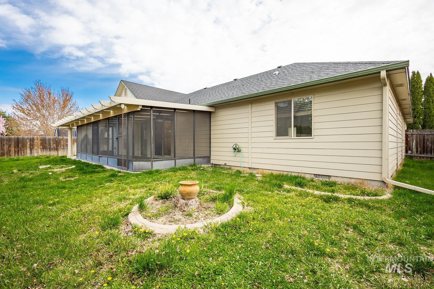 4227 North Rhodes Avenue Meridian, ID 83646 - Photo 42 of 42 Rear view of property with a sunroom and roof with shingles
