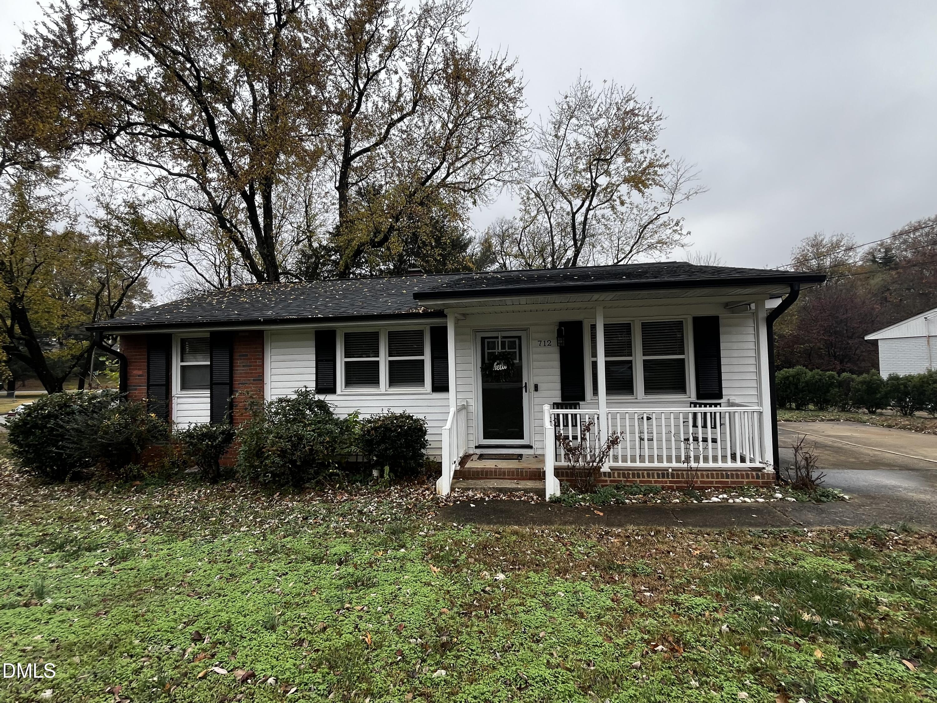 a front view of house with yard and outdoor seating
