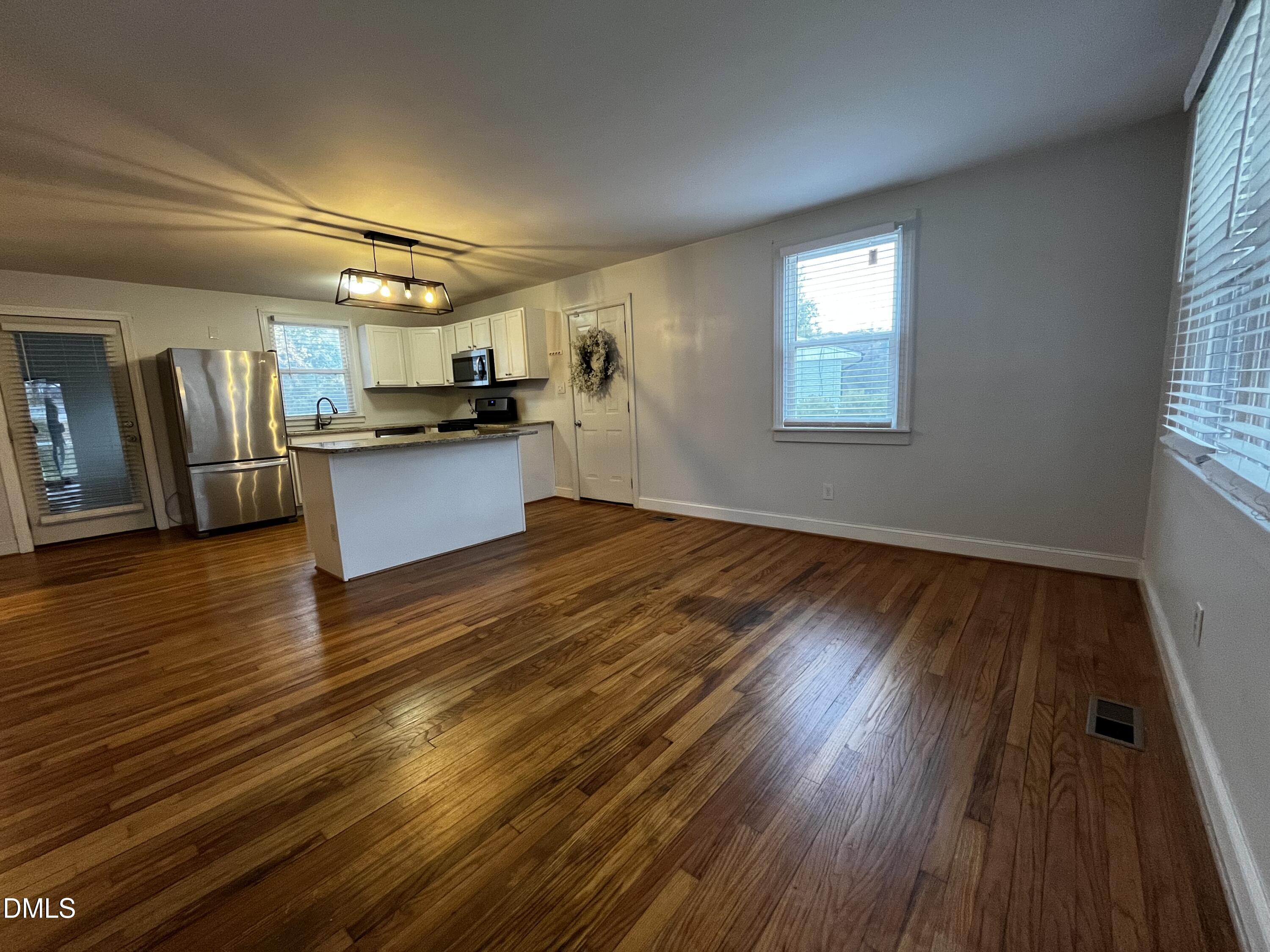 712 Hadley Road Raleigh, NC 27610 - Photo 3 of 11 a kitchen with a wooden floor and window