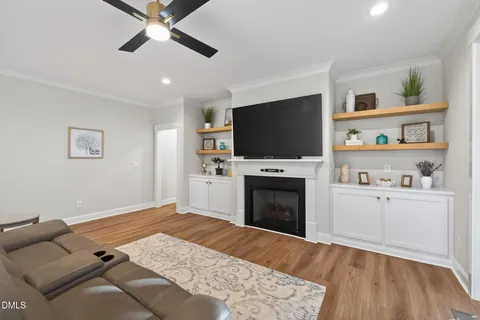 a living room with furniture fireplace and a flat screen tv