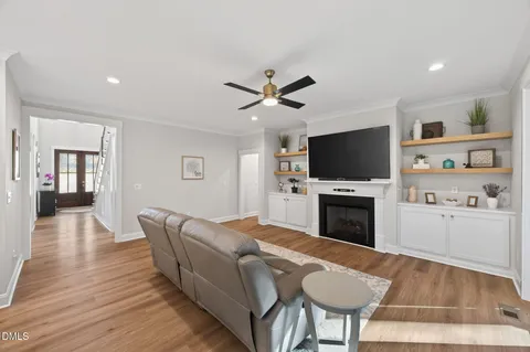a living room with furniture and a wooden floor