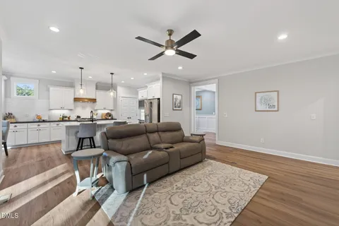 a kitchen with stainless steel appliances granite countertop a refrigerator and a stove top oven