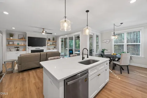 a dining room with furniture a chandelier and wooden floor