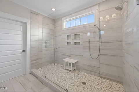 a view of a hallway with wooden floor and windows