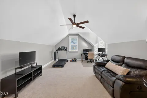 a view of chairs and deck in the backyard